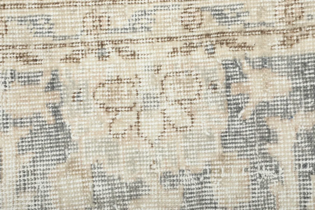 Extreme close-up showing the low pile and texture of the hand-knotted wool fibers.