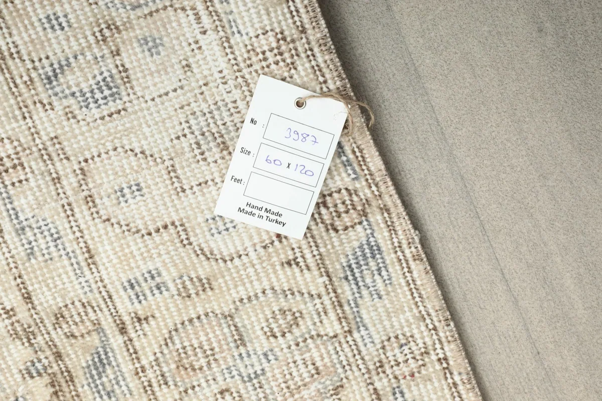 Close-up of the product tag indicating 'Hand Made in Turkey' and the rug's dimensions.