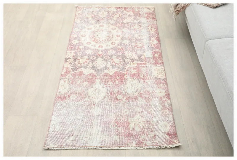 Full top view of the vintage rose and ivory floral medallion rug on a white background