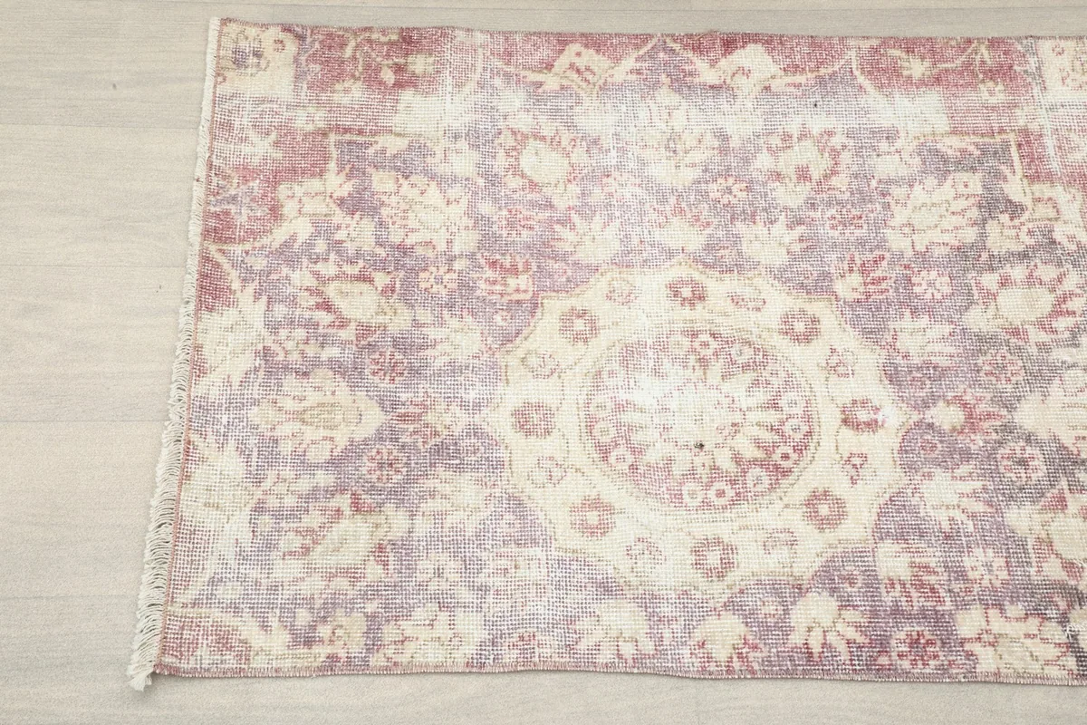 Close-up of the other end of the rose and ivory rug, showing the central medallion