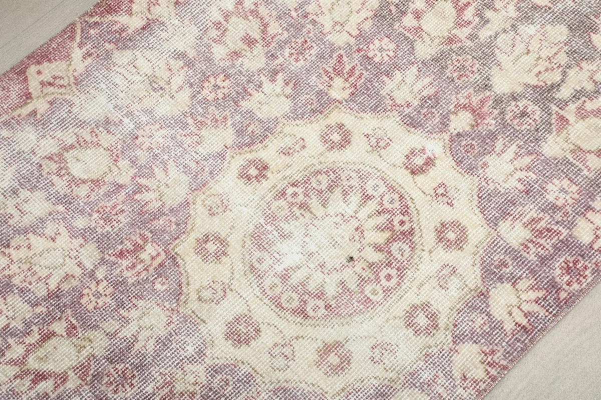 Detailed view of the central ivory medallion and surrounding rose floral motifs