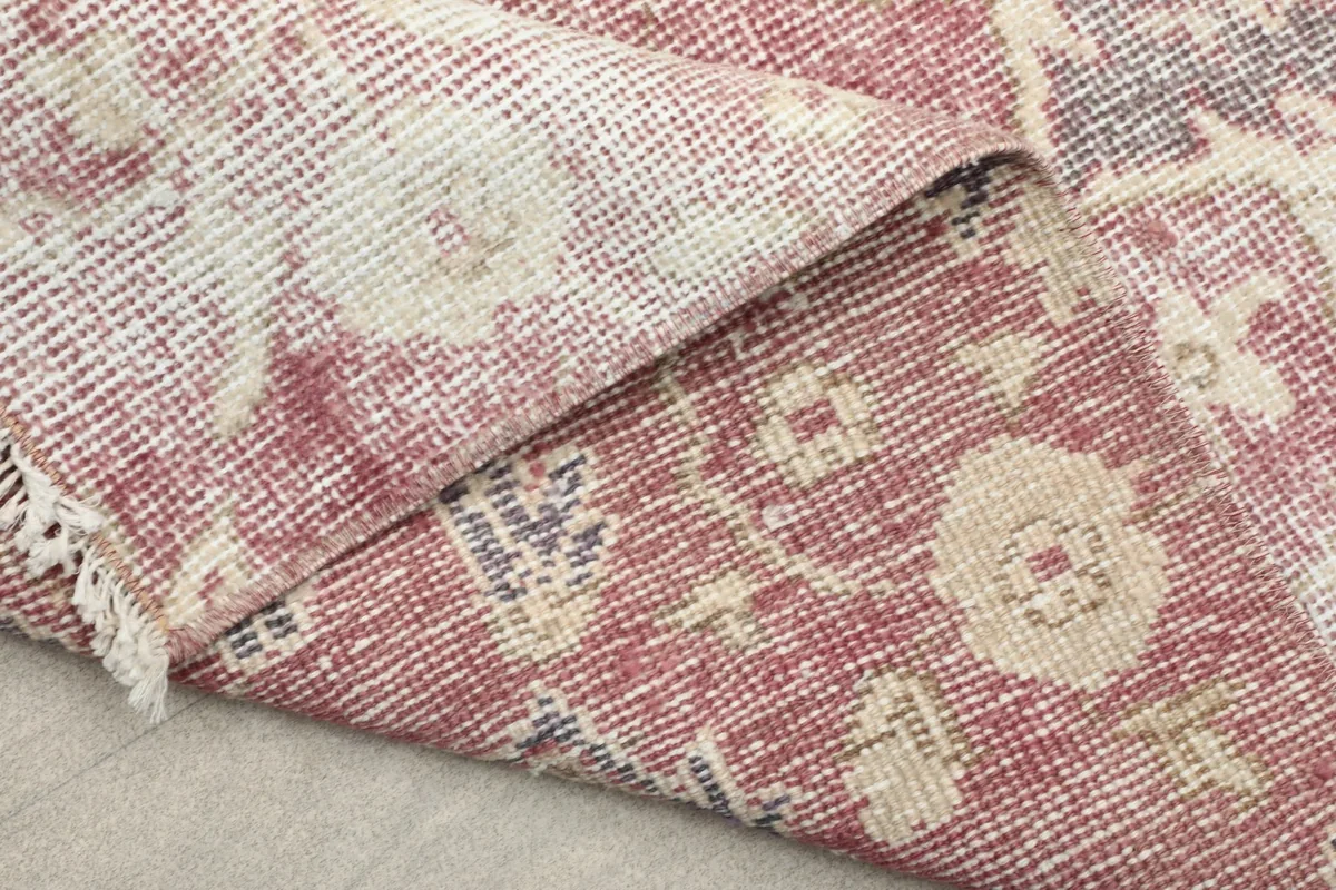 Another view of the folded rug, showing the back of the hand-knotted construction