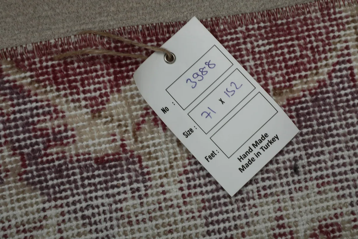 Product tag showing the rug's dimensions in centimeters and 'Hand Made in Turkey'