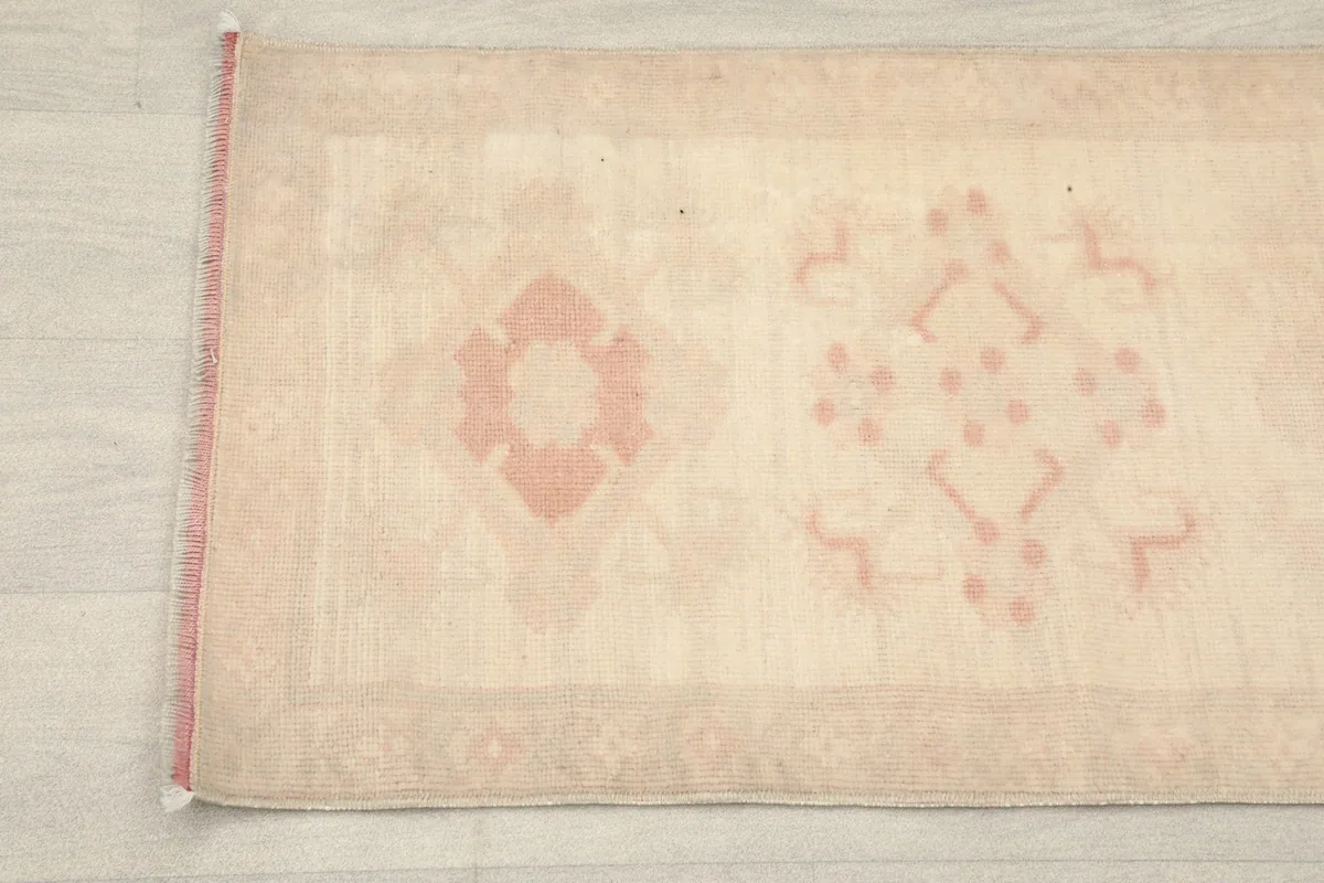 Close-up detail of the center of the runner rug, highlighting the subtle rose patterns.