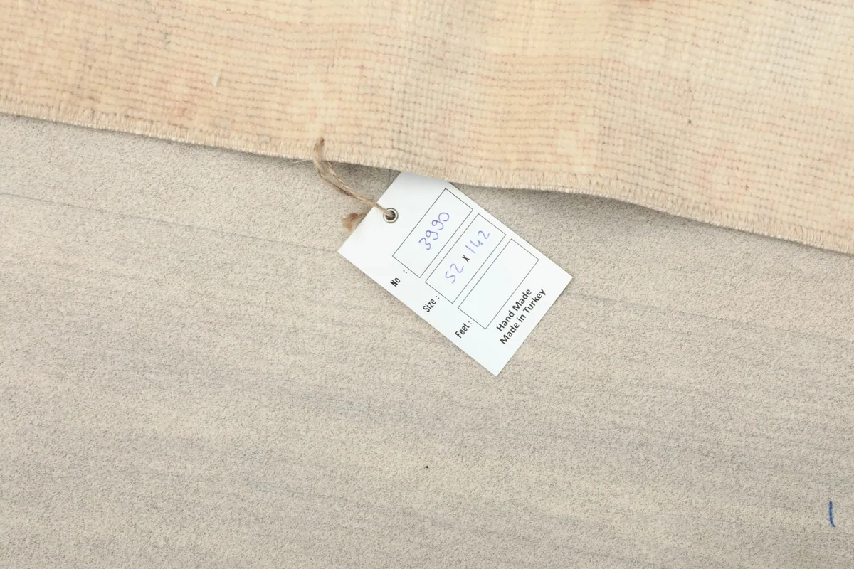 Close-up of the product tag indicating the rug's size and handmade origin from Turkey.