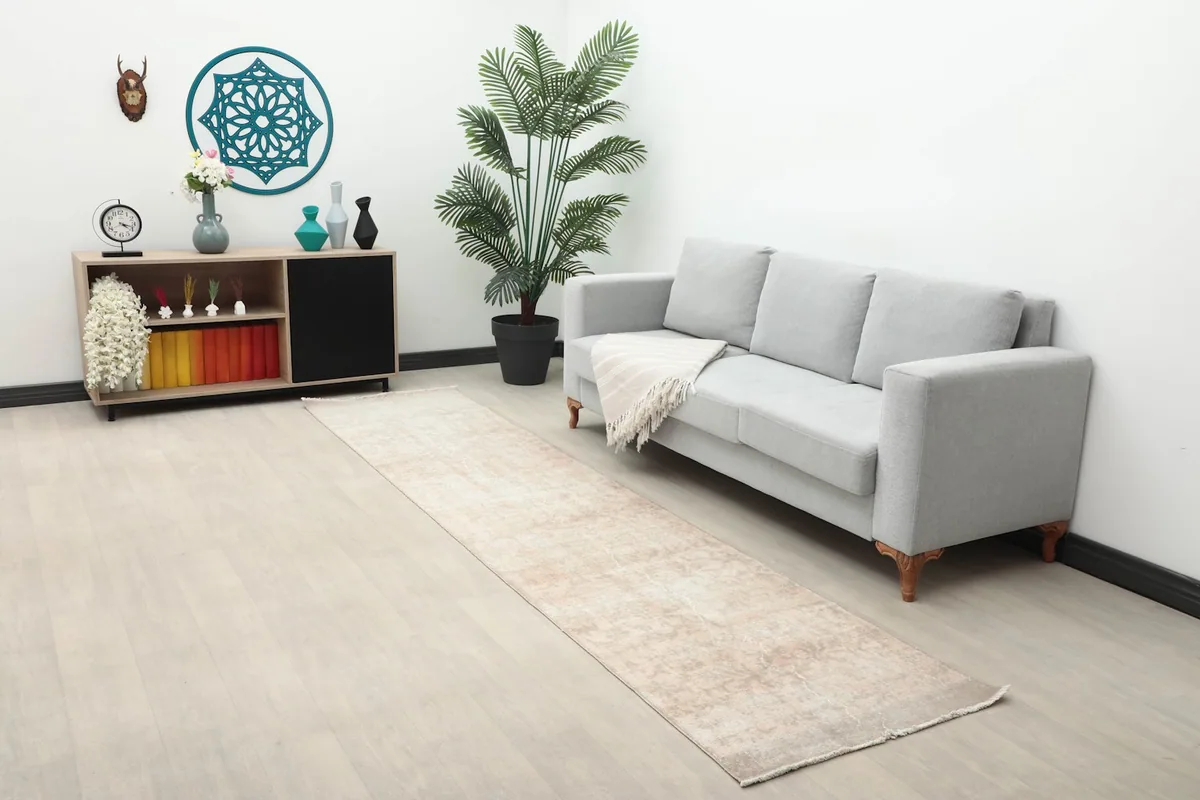 Wide view of the runner rug in a room with a sofa and decor, highlighting its integration into a home space.