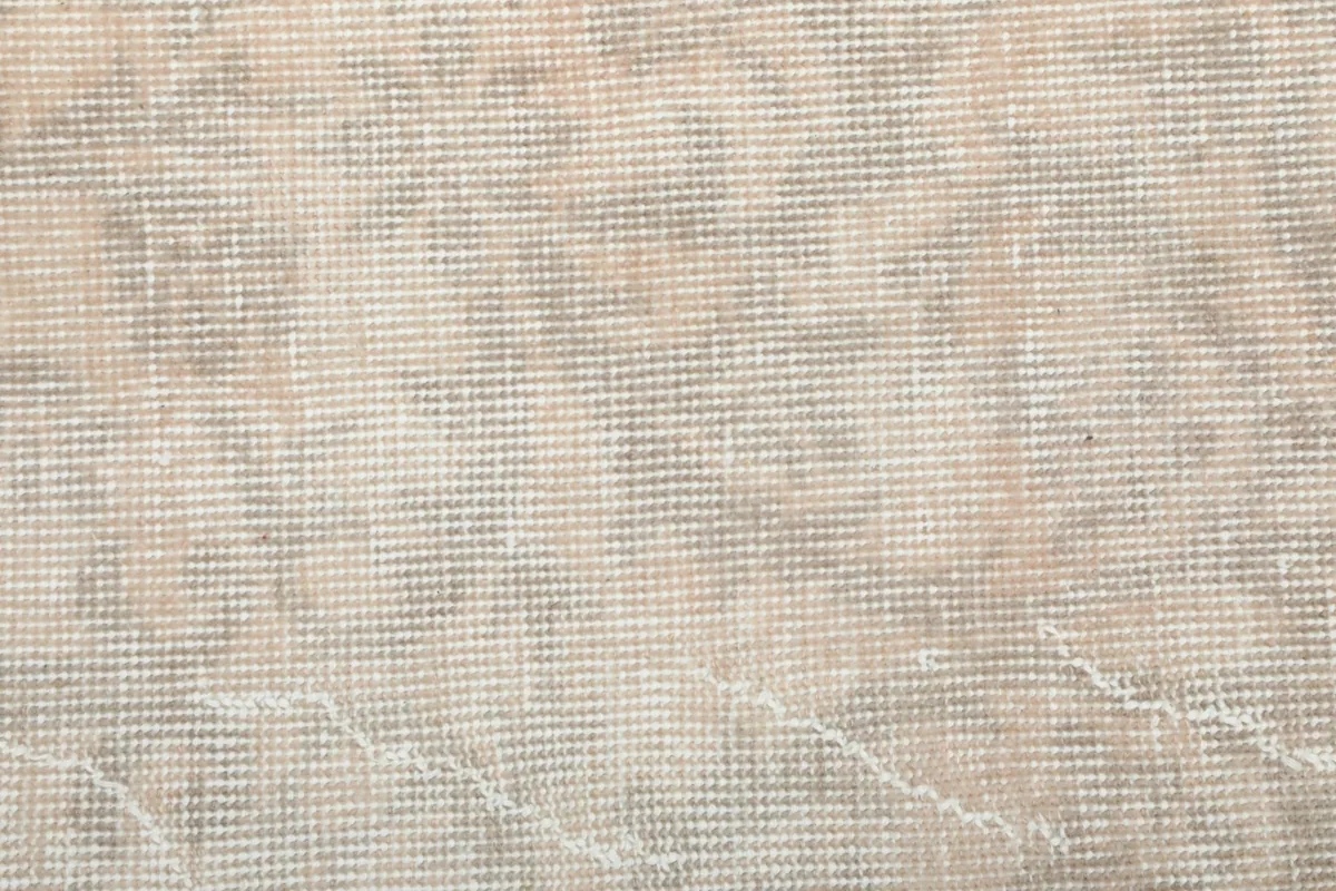 View of the rug's cotton foundation and the reverse side of the hand-knotted construction.
