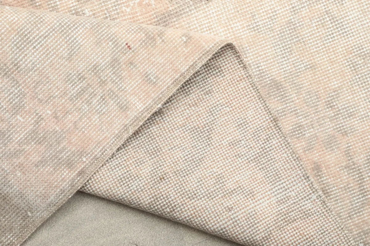 Another folded view of the rug, emphasizing the thickness of the wool pile and the sturdy cotton backing.