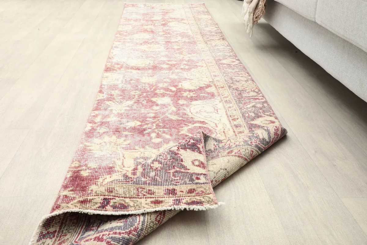 The runner partially rolled, demonstrating its flexibility and the consistent pattern from the top to the underside.