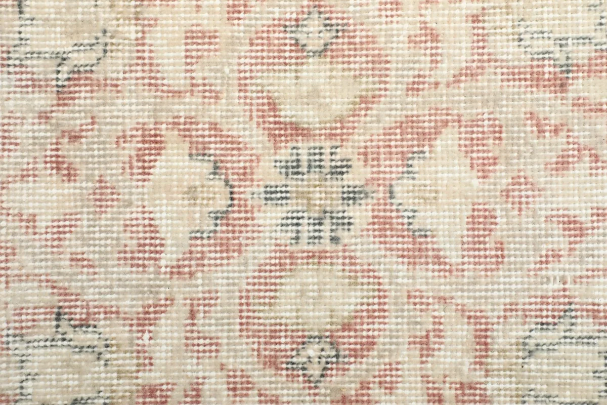 Extreme close-up of the hand-knotted wool pile, showing texture and color variation