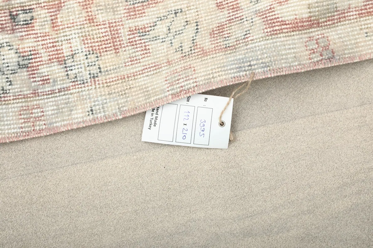 Close-up of the product tag attached to the rug, displaying size and origin information