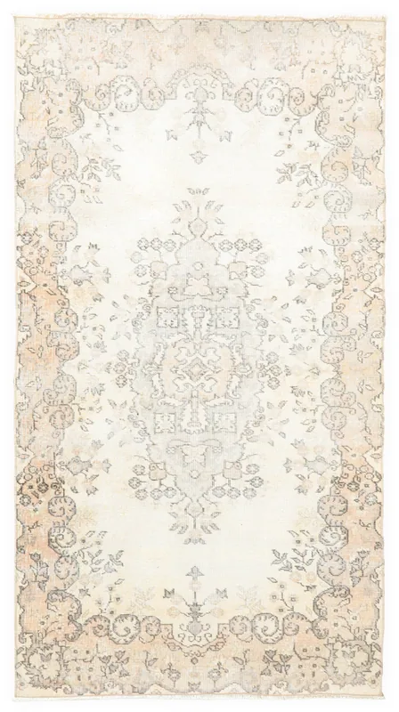Full overhead view of the ivory and beige vintage Anatolian area rug on a white background.