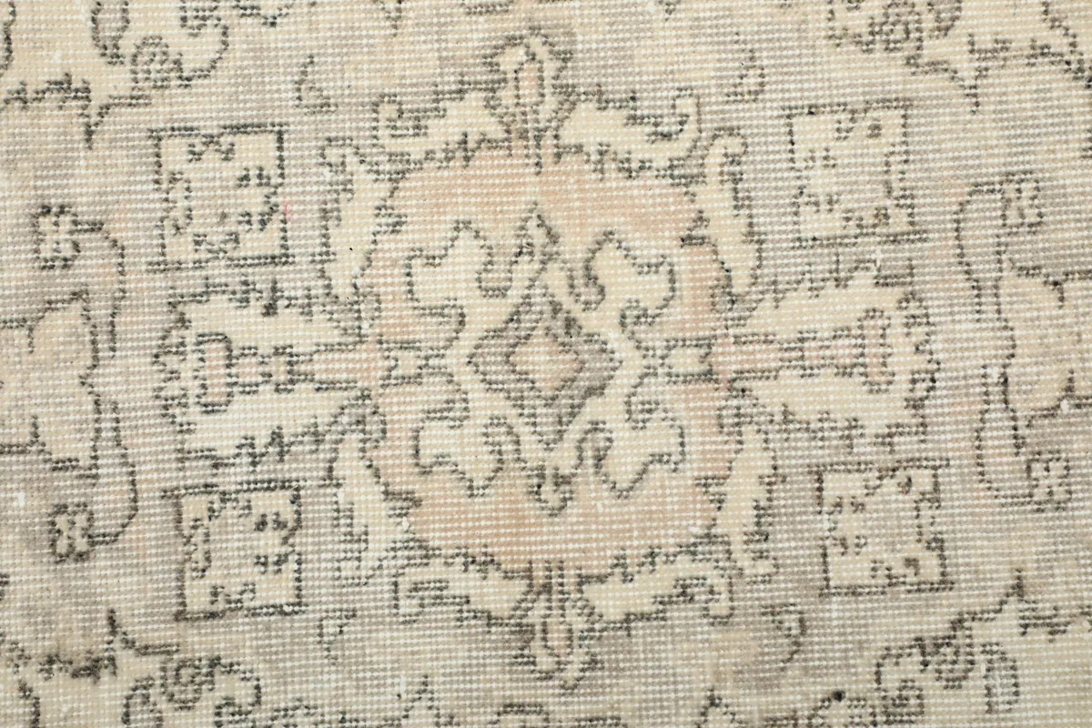 Extreme close-up of the rug's low pile, showcasing the intricate knotting and wool texture.