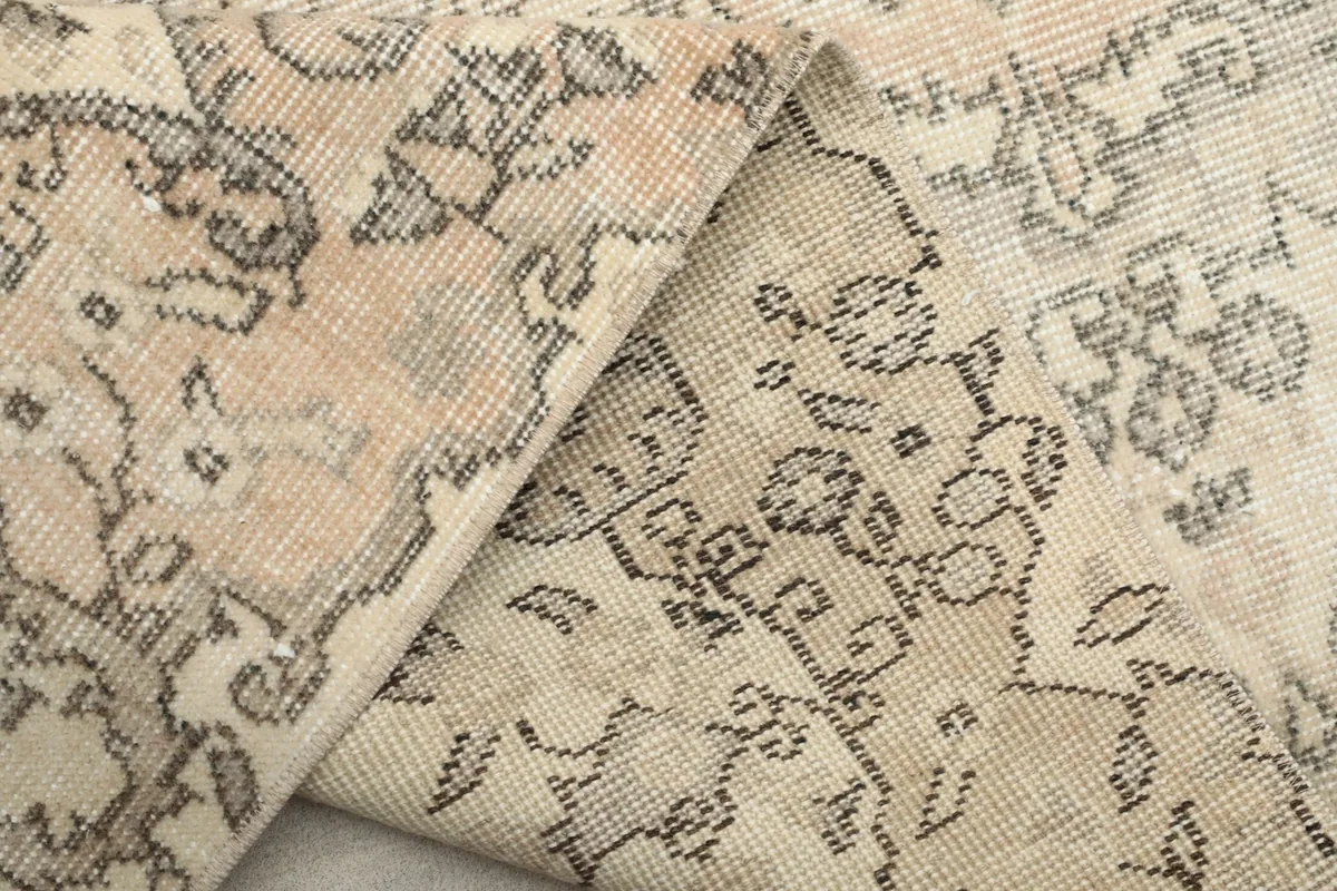 Another view of the rug folded, emphasizing the hand-knotted construction and the evenness of the foundation.