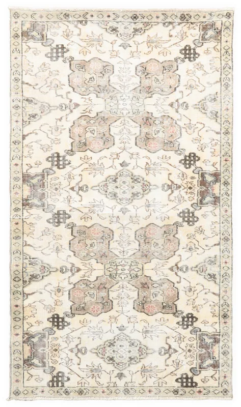 Full top view of the ivory and brown vintage Anatolian rug with tribal medallion design