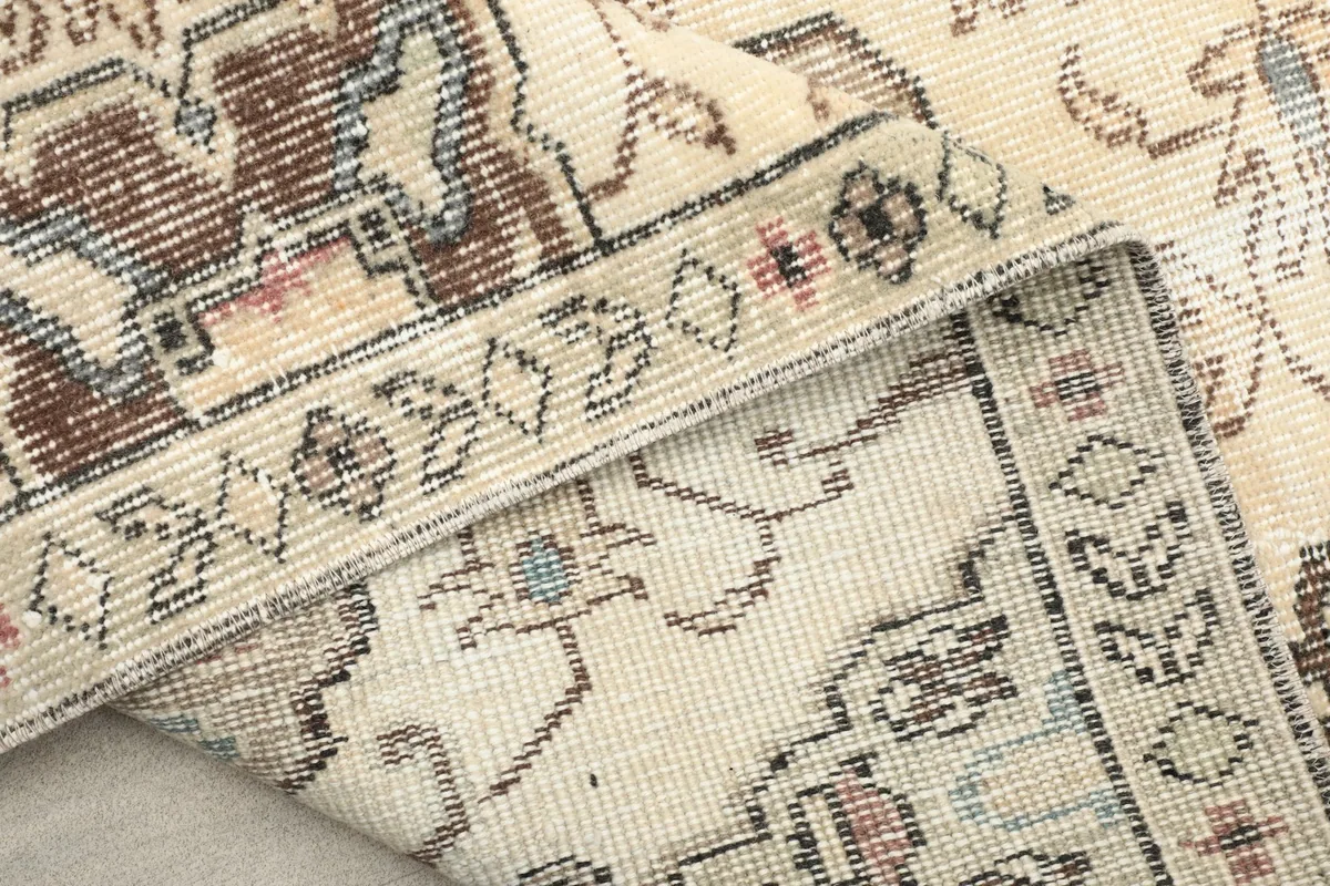 Detailed view of the low wool pile and the intricate knotting of the rug