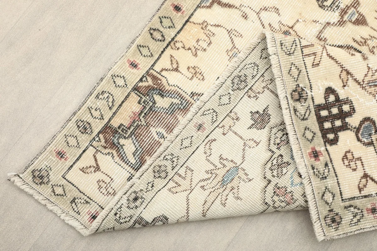 View of the back of the hand-knotted rug, revealing the cotton foundation and construction