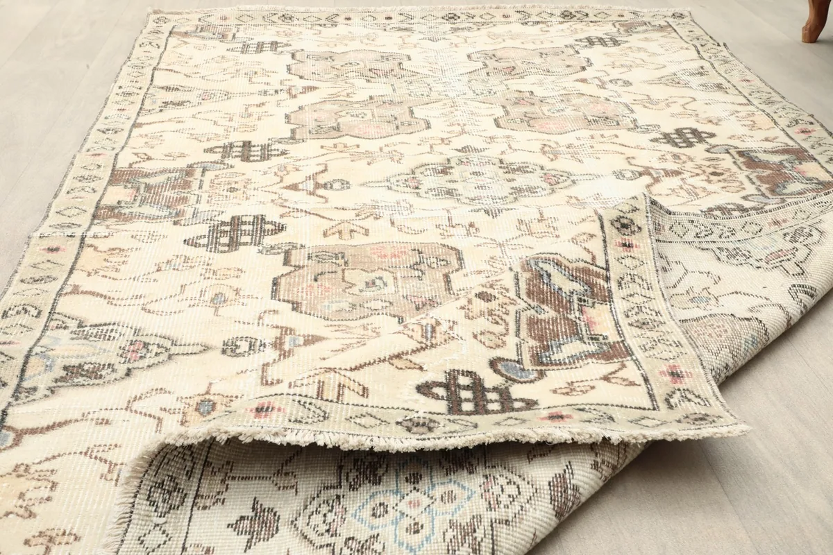 Folded section of the rug showing the thickness and flexibility of the vintage material