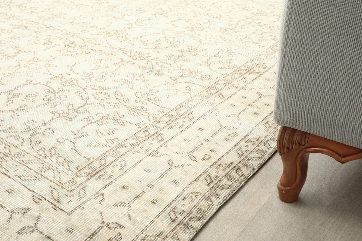 Detail of the rug extending under a sofa, showing its integration into a living space.
