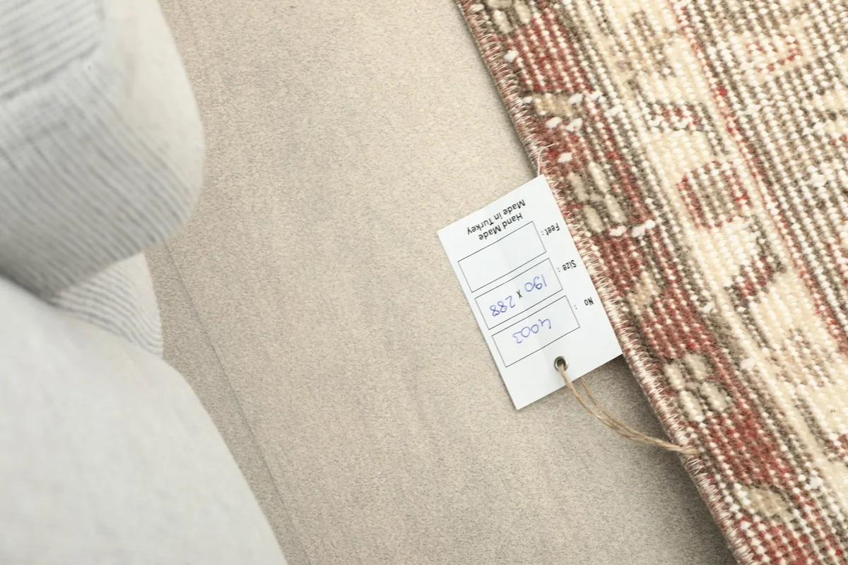 Close-up of the product tag attached to the rug, showing details and origin