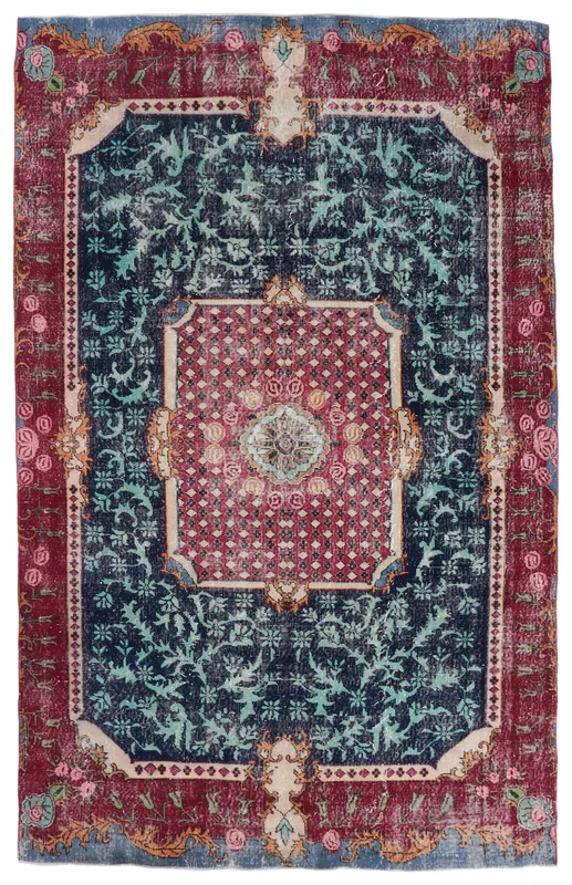Full overhead view of the navy and red vintage Anatolian rug on a white background