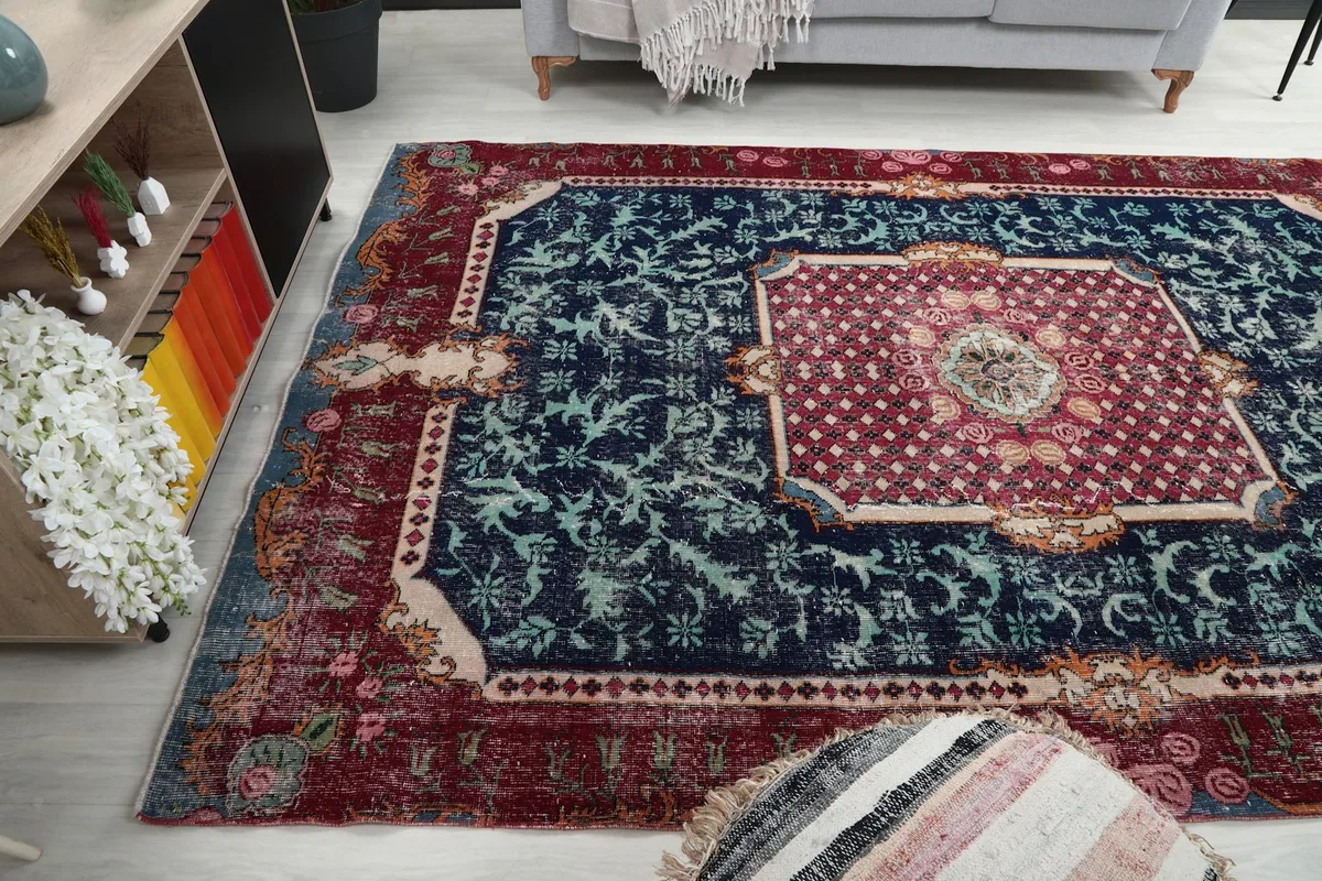 Wide angle view of the vintage rug in a living room setting with decorative accents