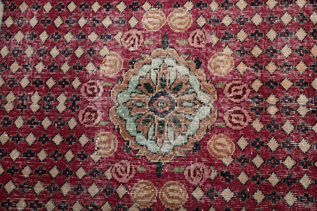Close-up of the central red medallion with intricate floral and geometric details