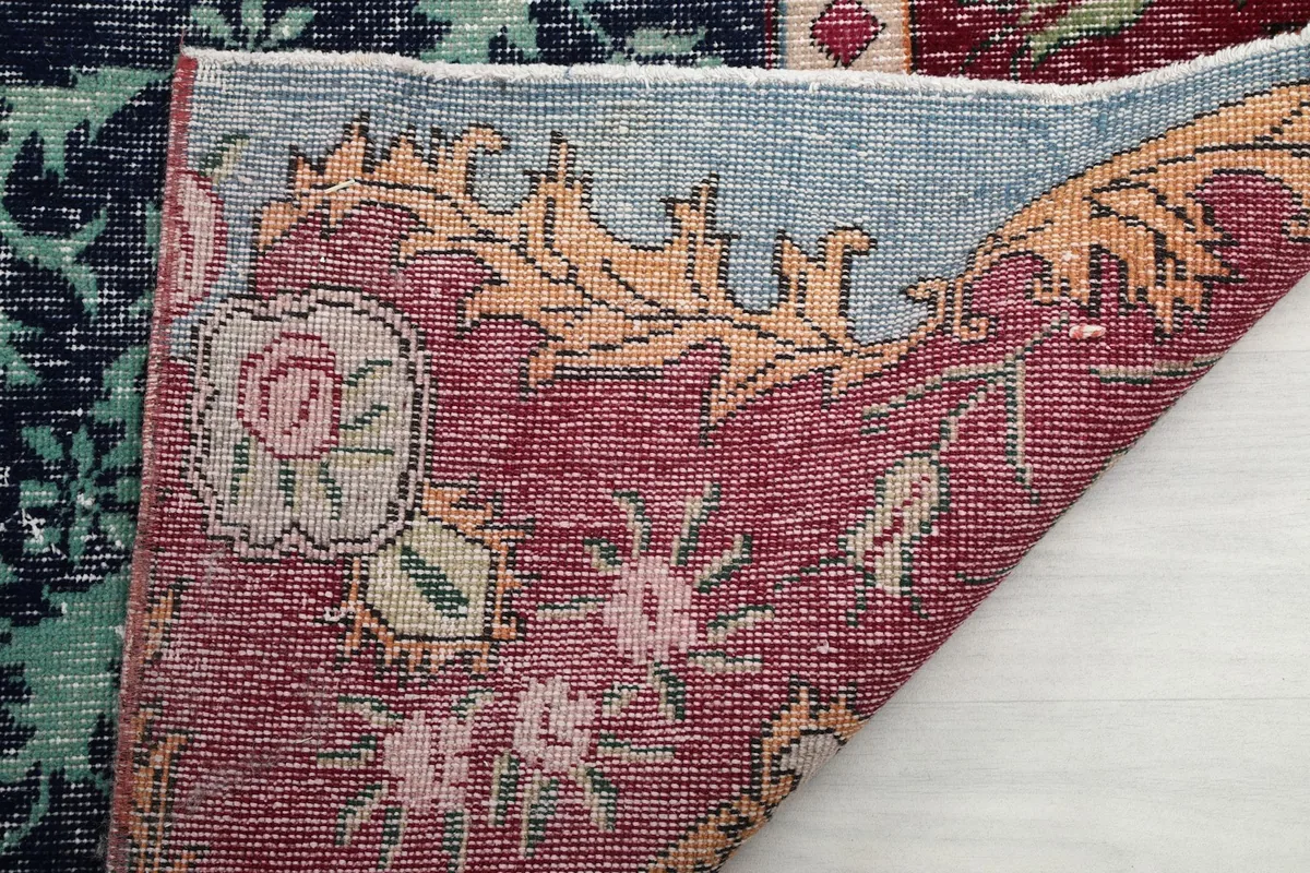 Close-up of the rug's reverse side, showing the hand-knotted wool on cotton foundation