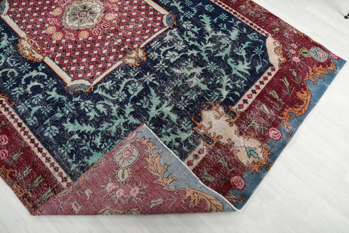 Folded corner of the rug revealing the reverse side and cotton foundation