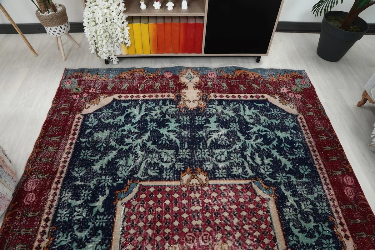 Overhead view of the rug's top half, showing the navy field and red medallion