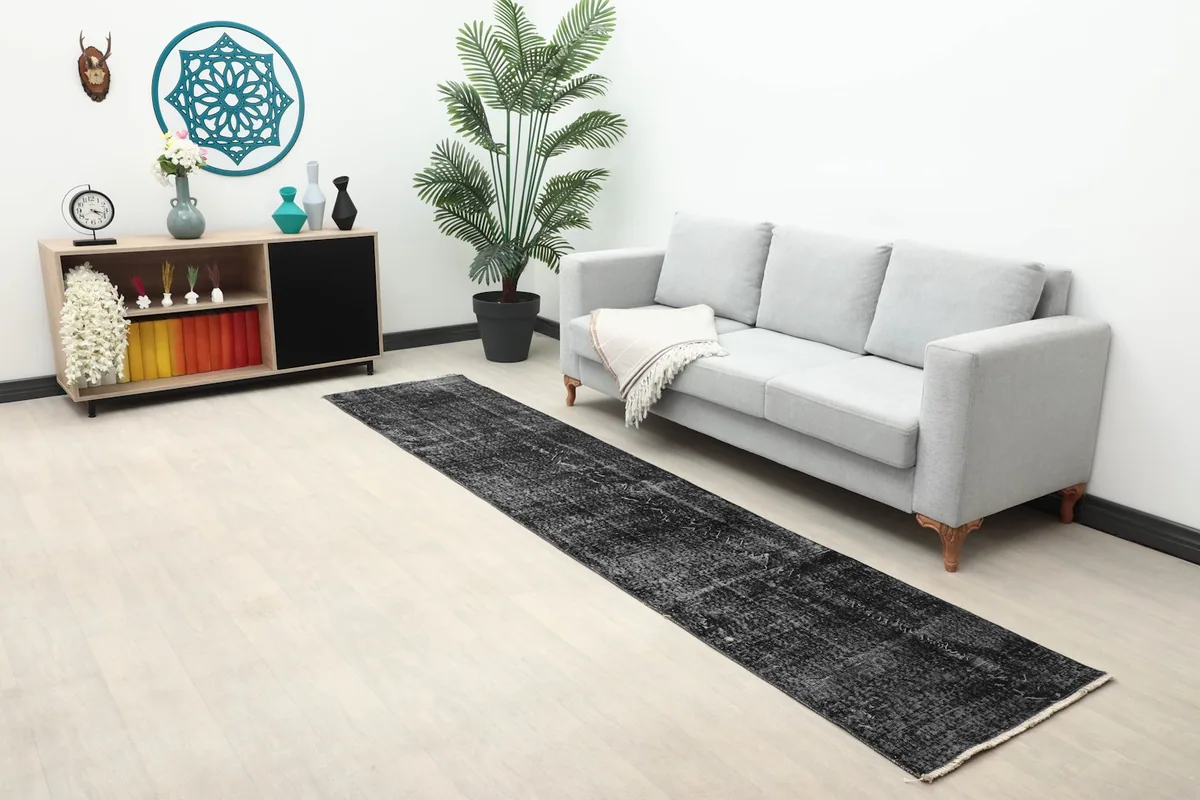 Wider view of the charcoal runner in a room with a sofa and side cabinet