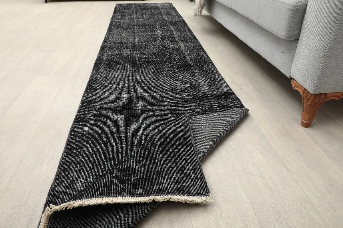 Runner partially folded, showing flexibility and the back of the rug