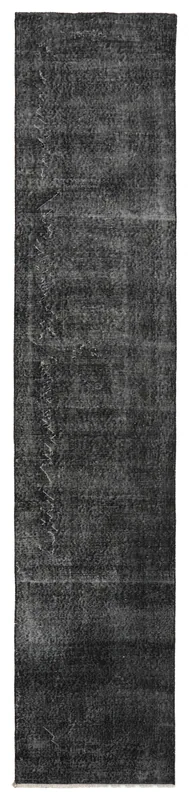 Full overhead view of the charcoal and black distressed vintage Anatolian runner rug