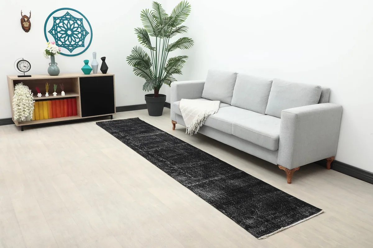 Long shot of the charcoal runner rug in a living area with minimalist decor