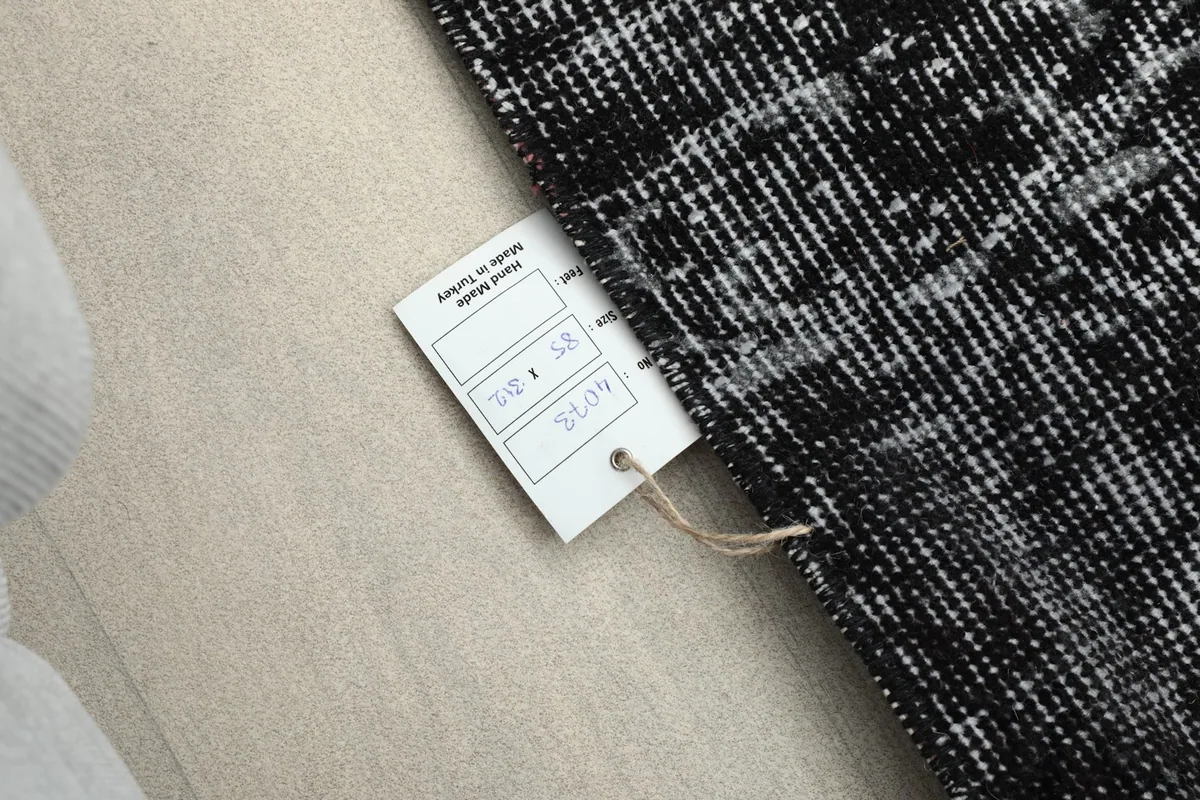 Close-up of the rug's label, indicating its size and origin from Turkey.