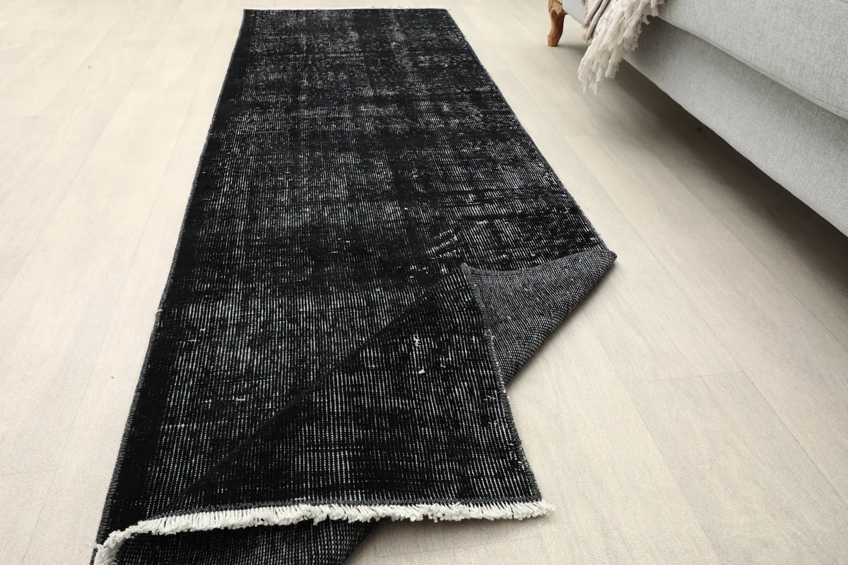 Angled view of the runner with one end slightly folded to show thickness