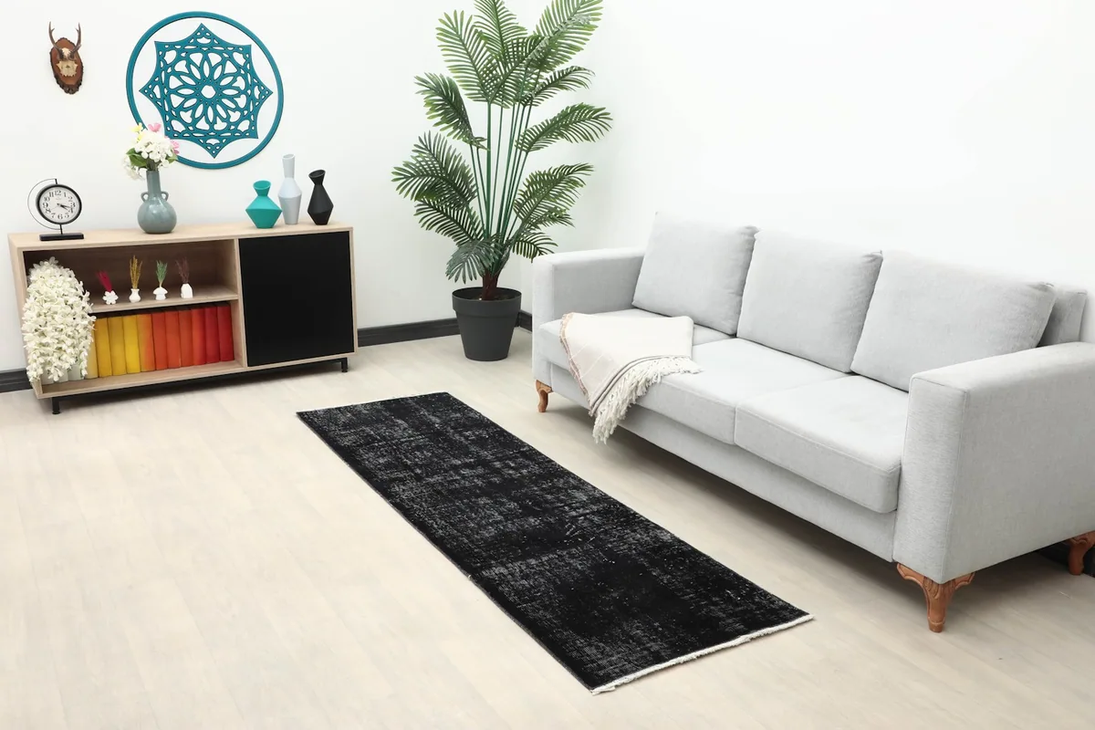 Long view of the distressed charcoal runner rug in a modern living space