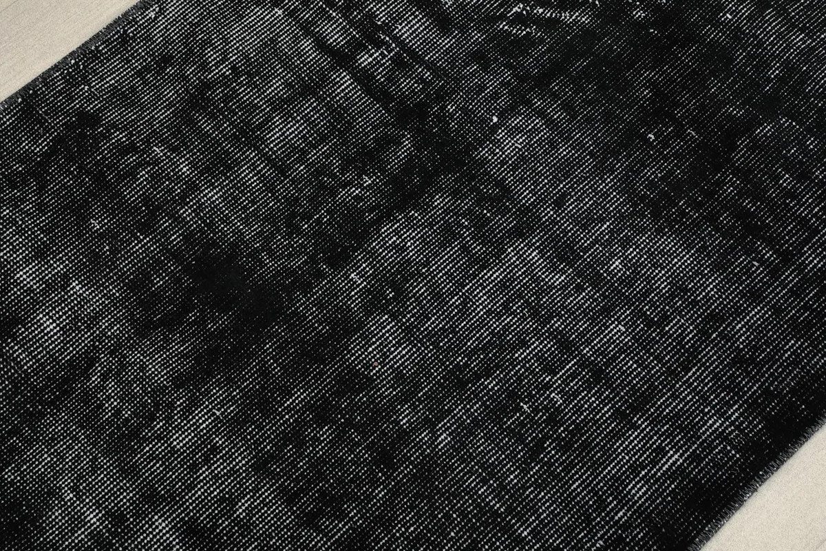 Close-up of the low wool pile and hand-knotted construction of the rug