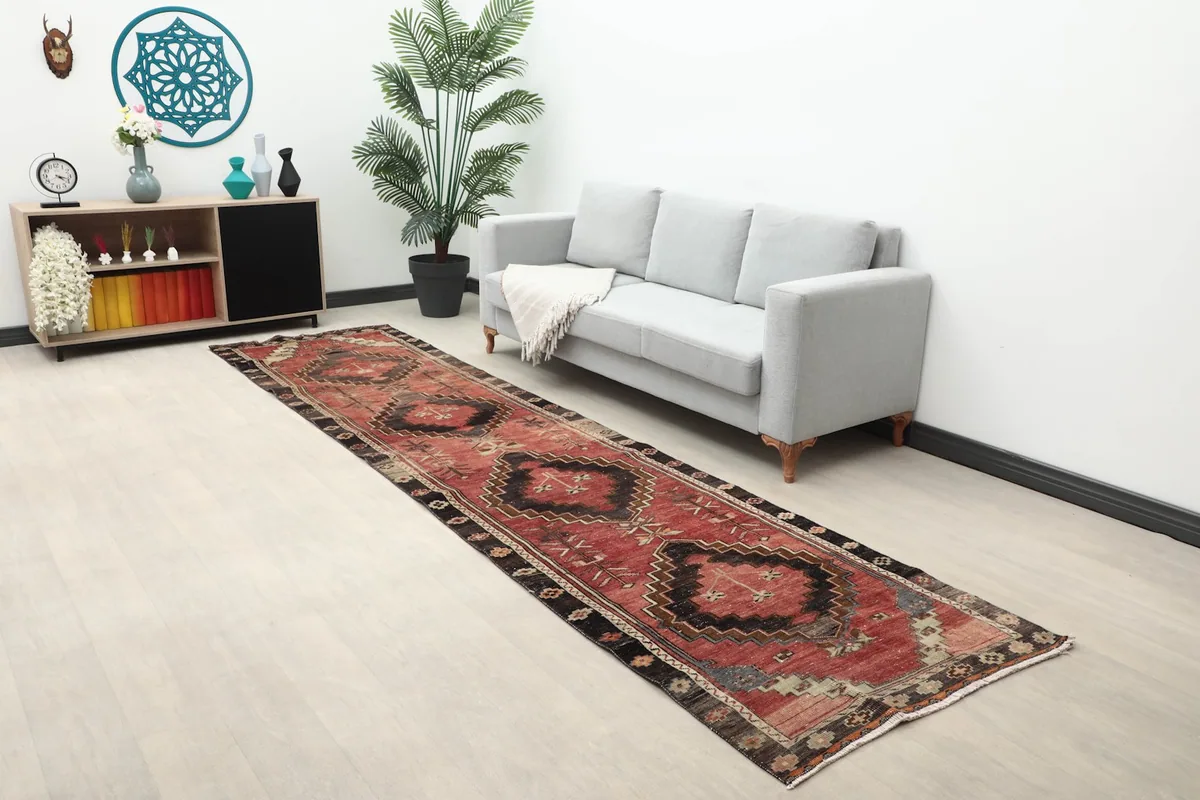 Long view of the red and black runner rug extending through a hallway or living area