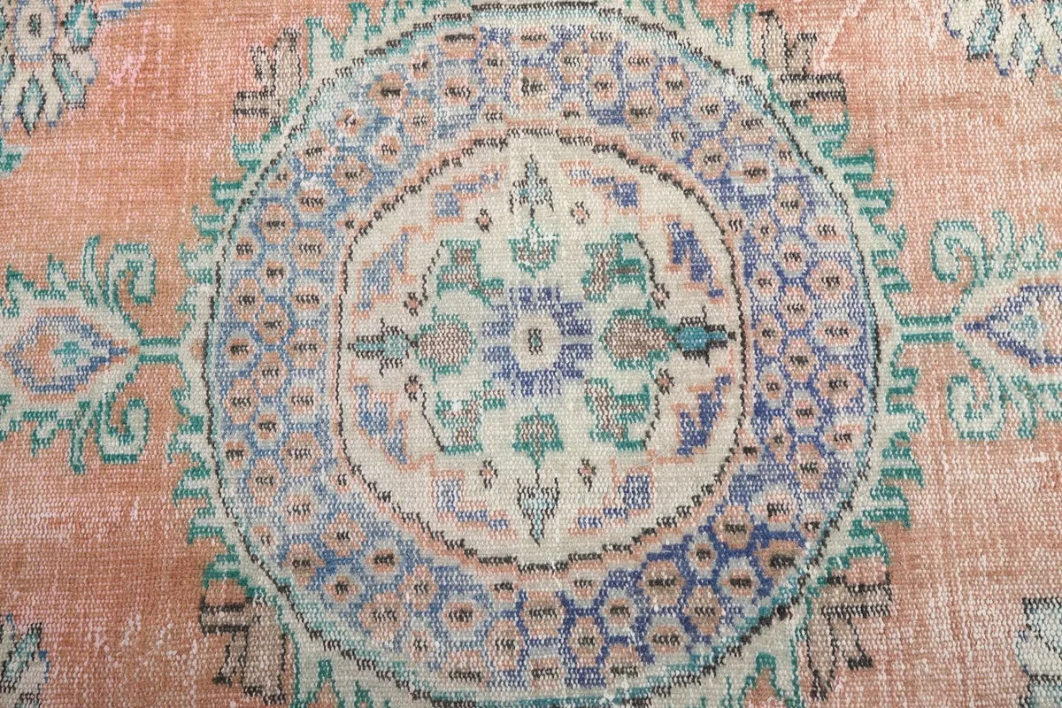 Close-up detail of the intricate blue and ivory central medallion design