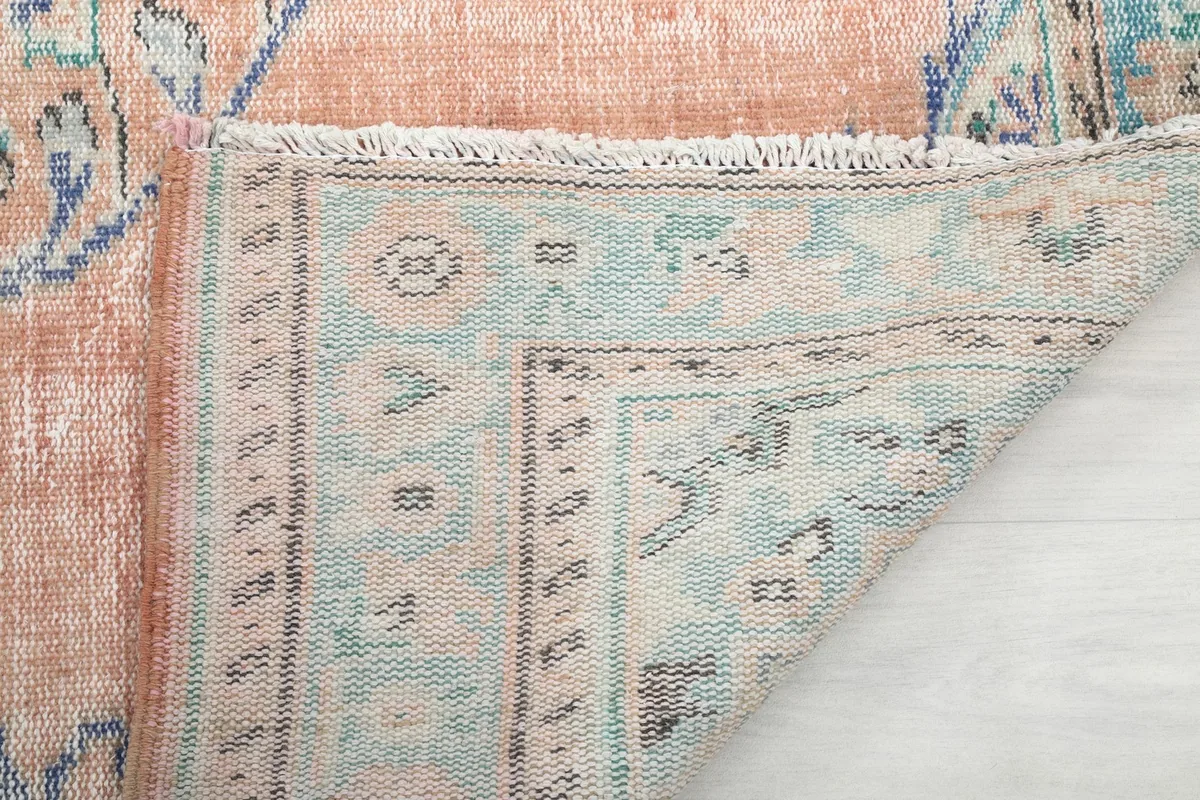 View of the rug's backside, revealing the hand-knotted construction