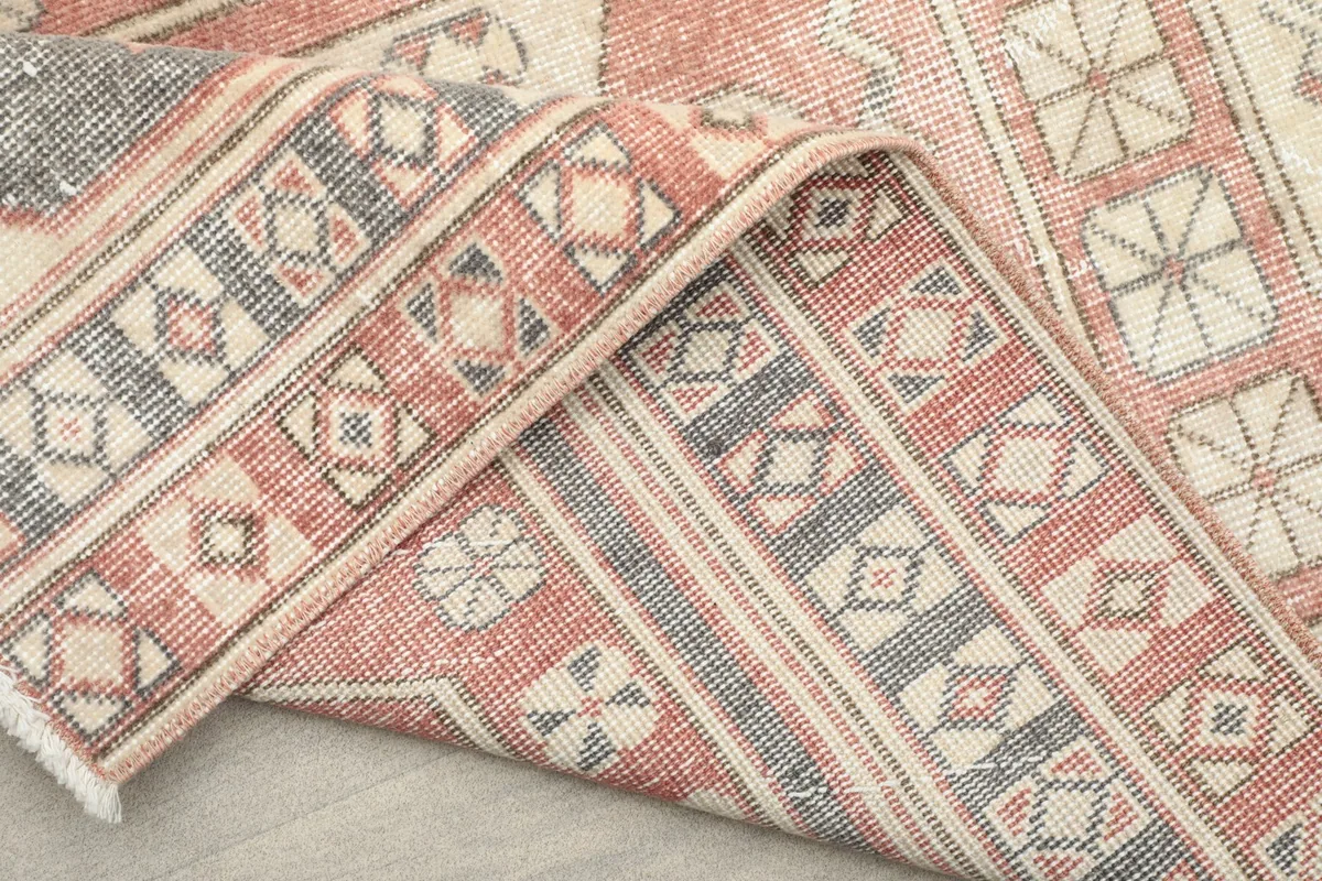 The rug folded to reveal the reverse side and the construction of the hand-knotted pile.