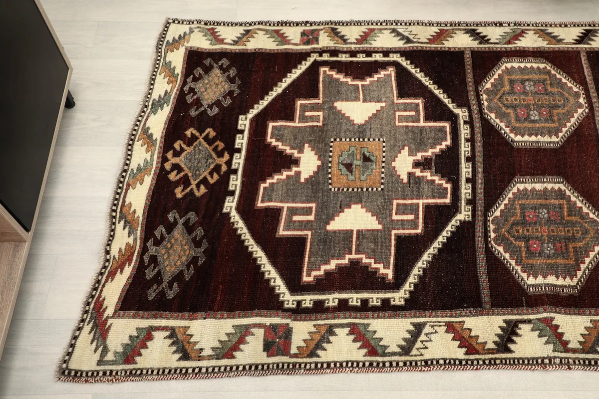 Overhead angle shot of the runner, focusing on the central and border patterns in red, gray, and ivory