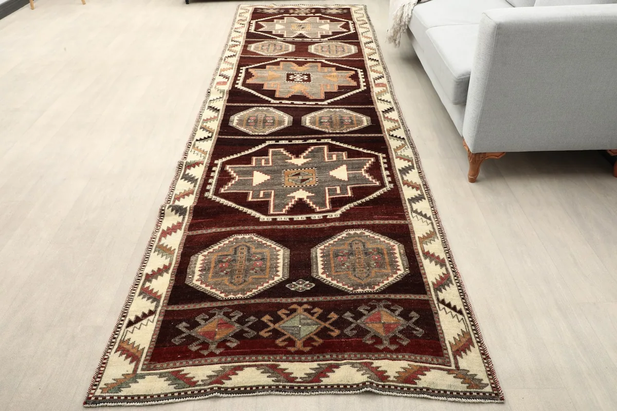 Vintage runner rug in a modern living space, showing its length and scale next to a sofa