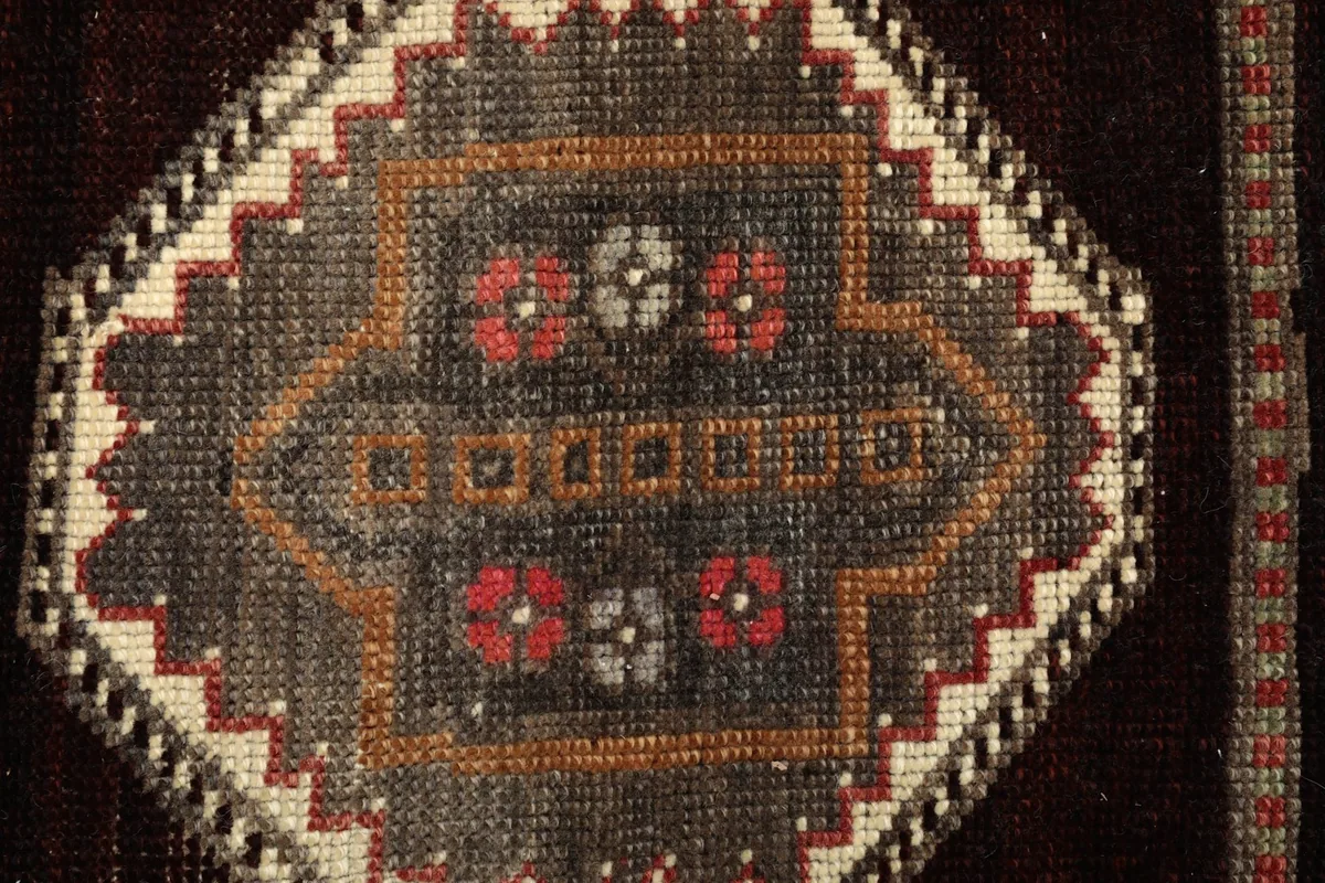 Close-up of a smaller hexagonal motif with red and orange accents within the runner's design