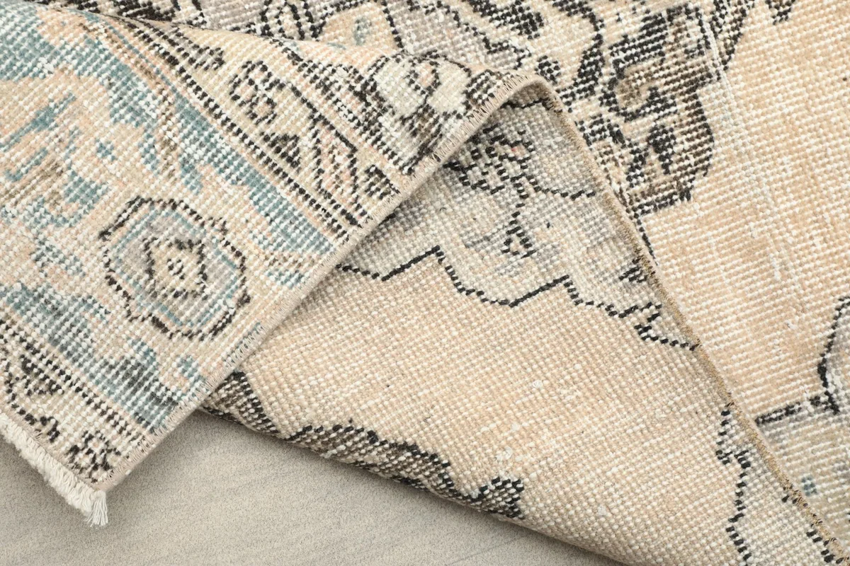 View of the reverse side of the runner rug, showing the knotting and foundation