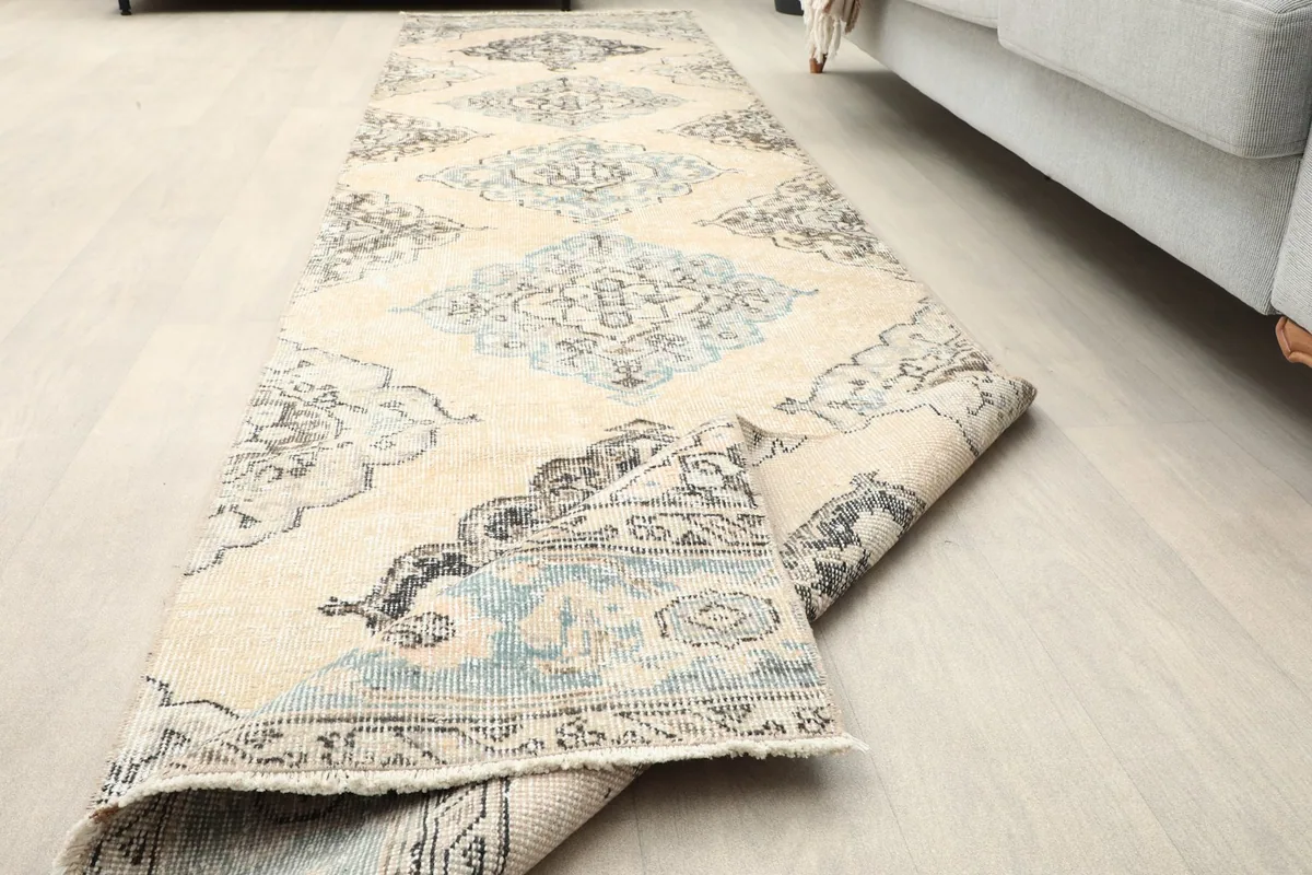 Runner rug partially rolled, showcasing its flexibility and the patterns