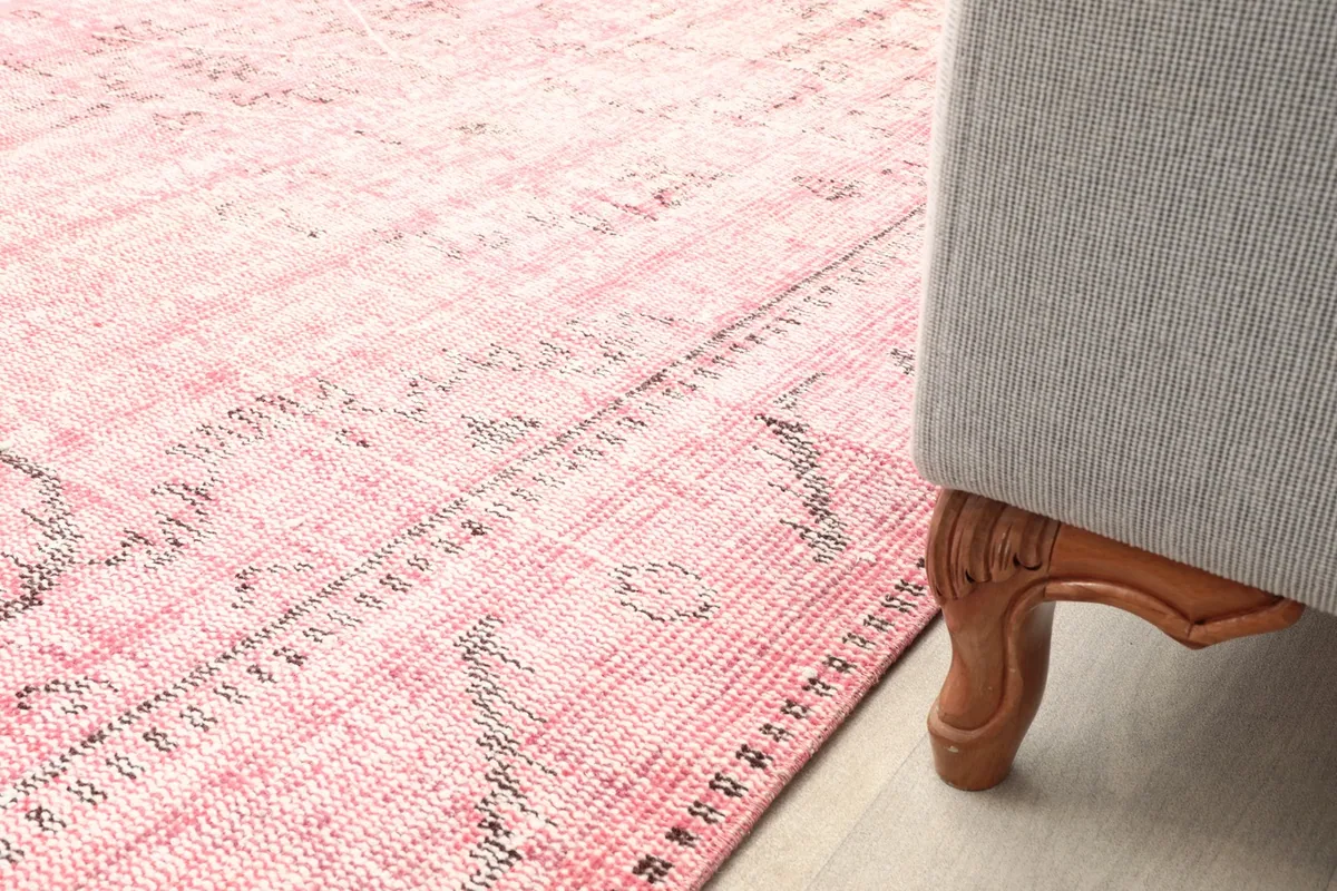 Rug placed under a sofa, showing its presence and how it defines the seating area