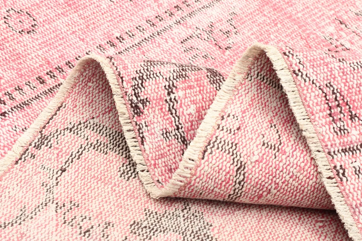Close-up of the low pile and texture of the hand-knotted vintage wool rug