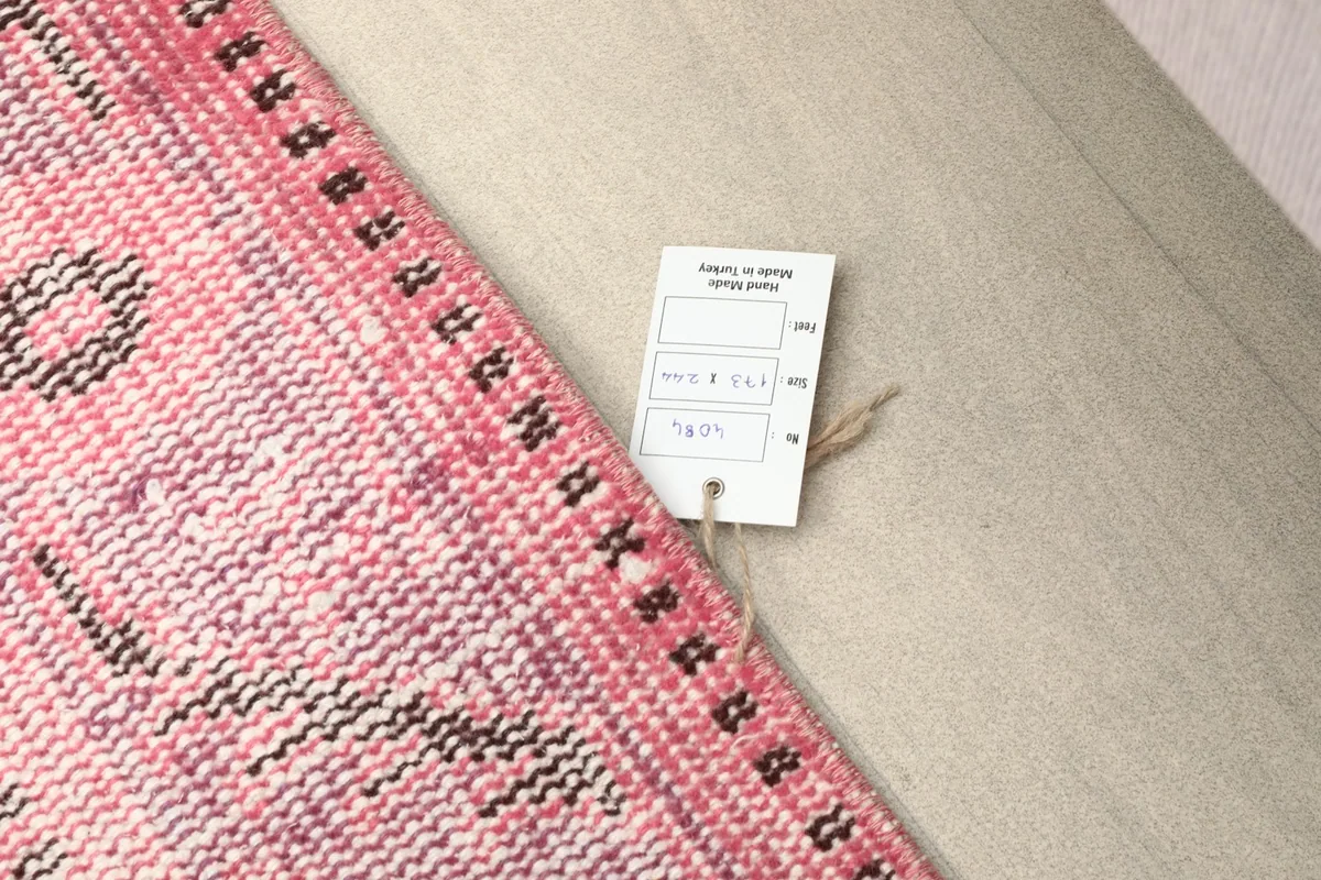 Product tag attached to the rug's corner, showing origin and material information